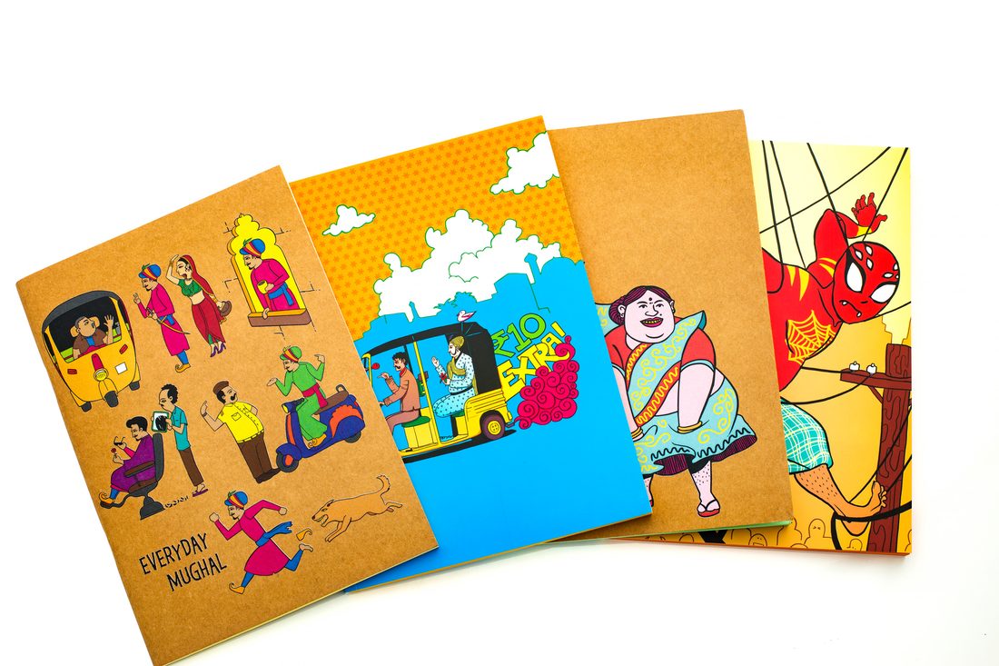 MonkeyJi notebooks fanned open, showing the coloured inner pages